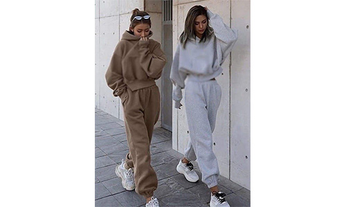 Two women walking on the street wearing sweatpants