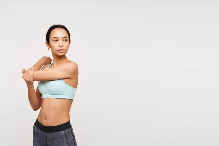 Model in a sporty bra stretching
