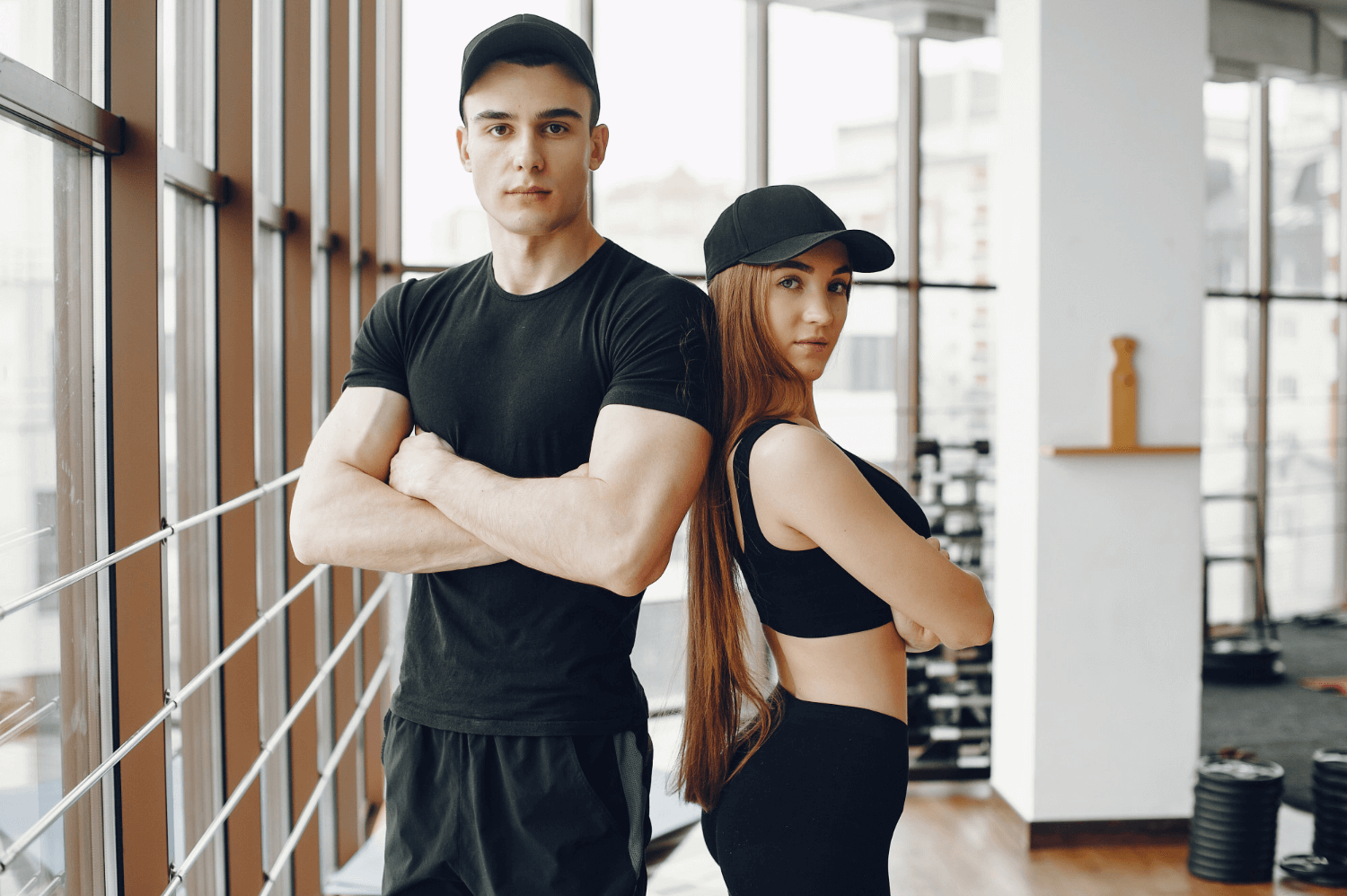 A Couple Wearing Sports Clothes in the Gym