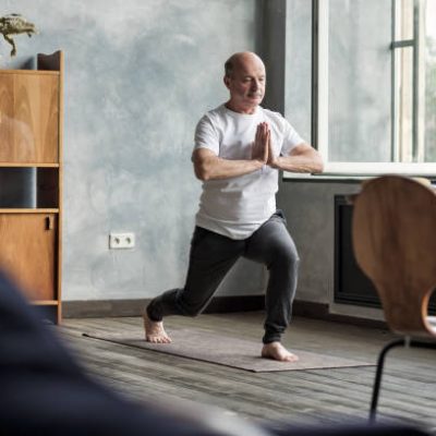 Elderly Man doing Yoga Indoor